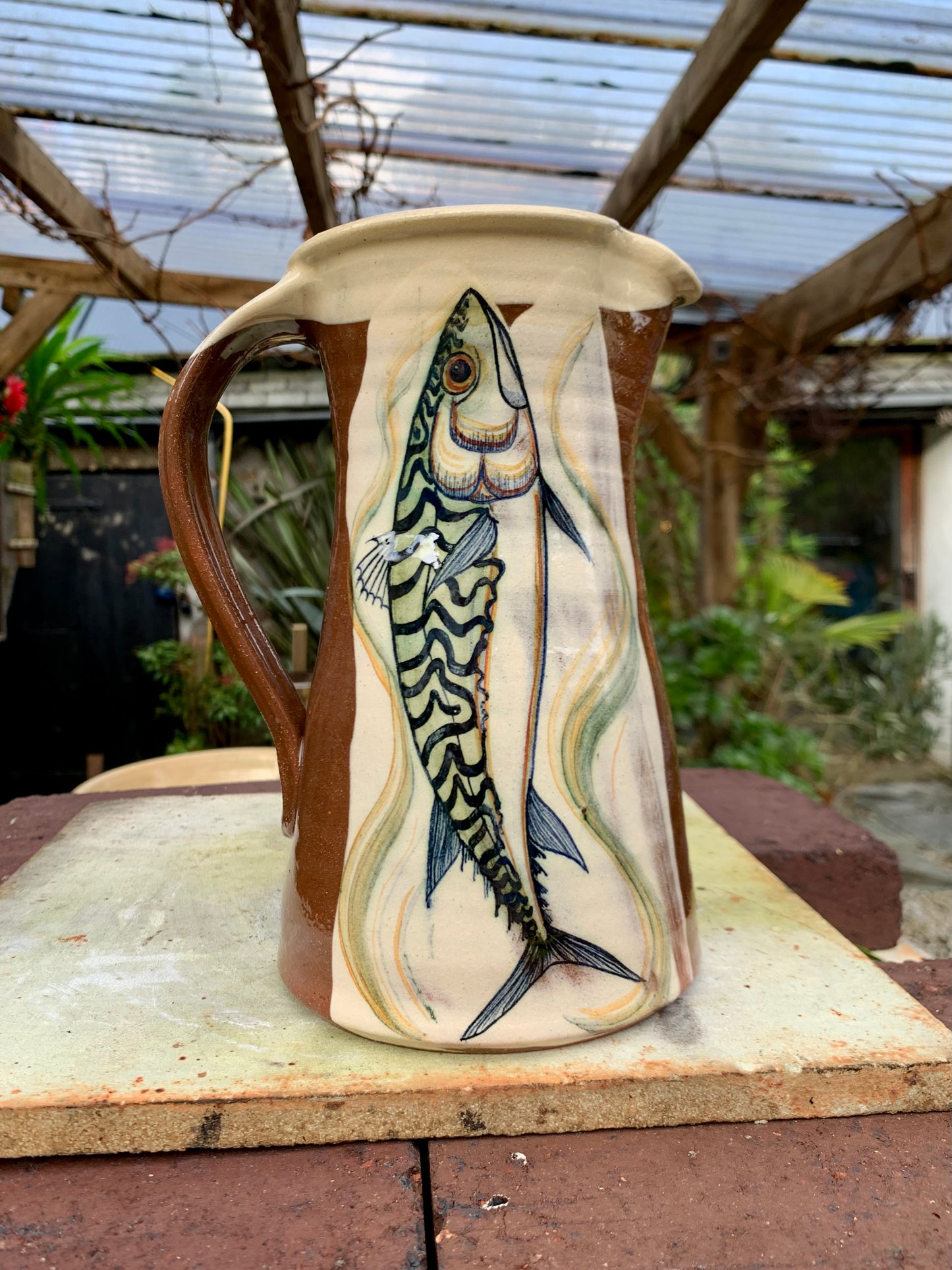 Terracotta jug, fish decoration