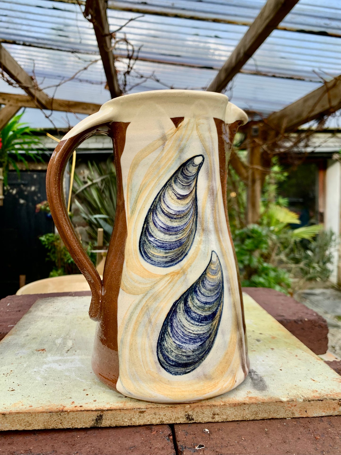 Terracotta jug, fish decoration