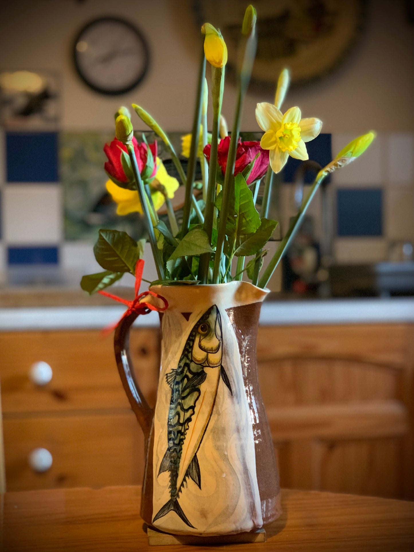 Terracotta jug, fish decoration