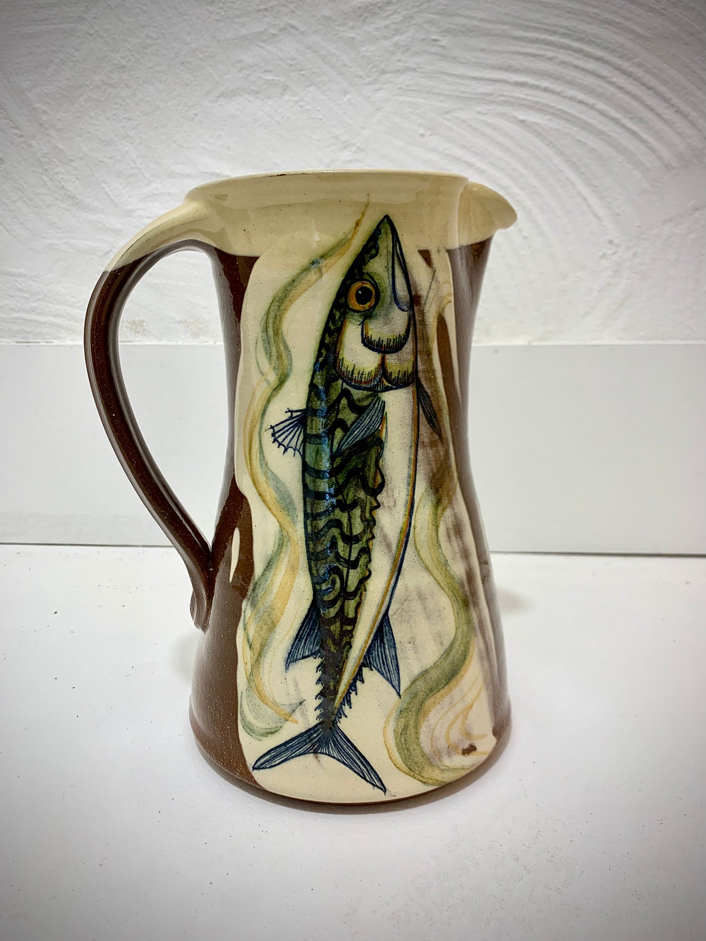 Terracotta jug, fish decoration