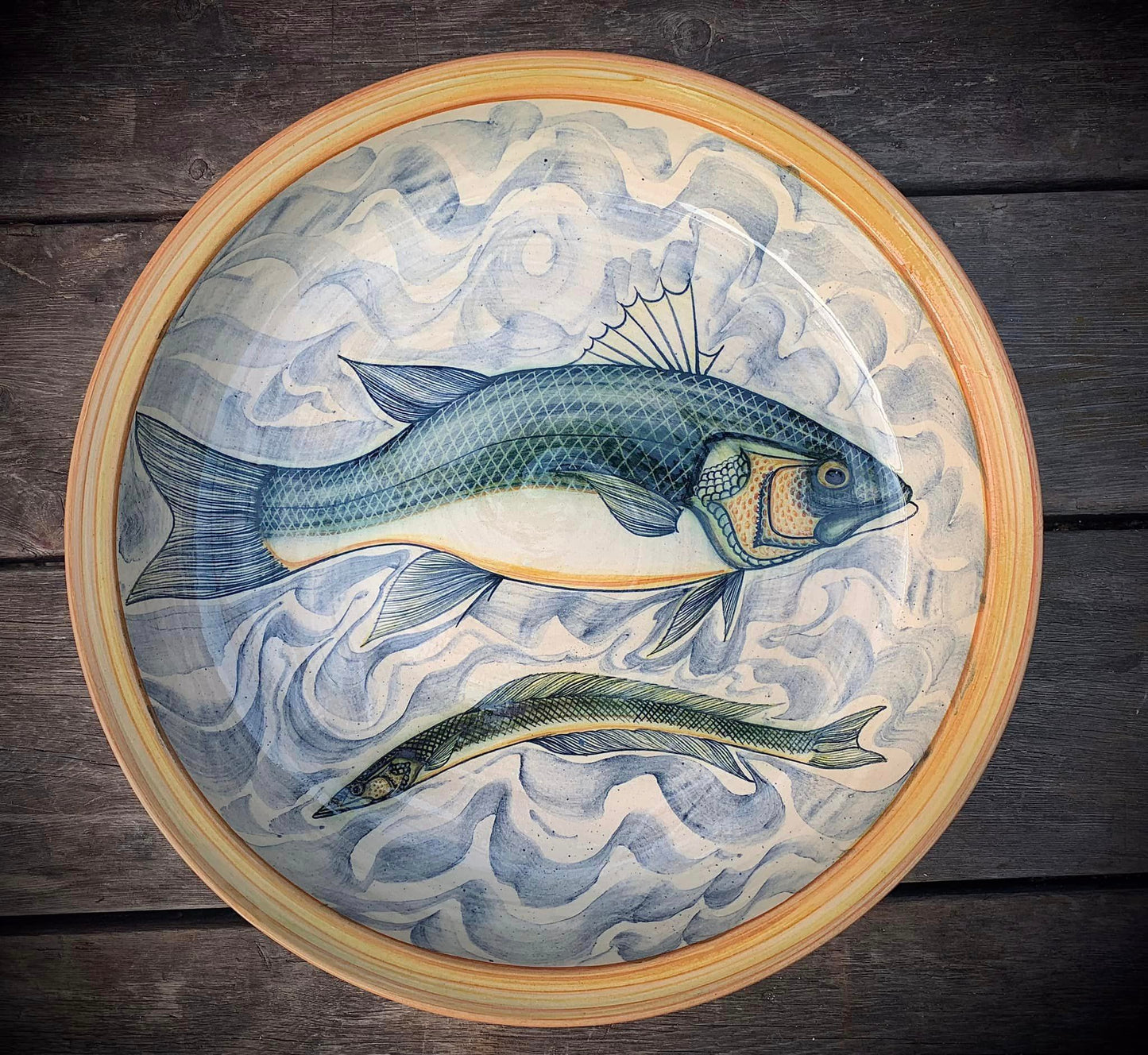 Pottery charger with fish decoration 35 cms